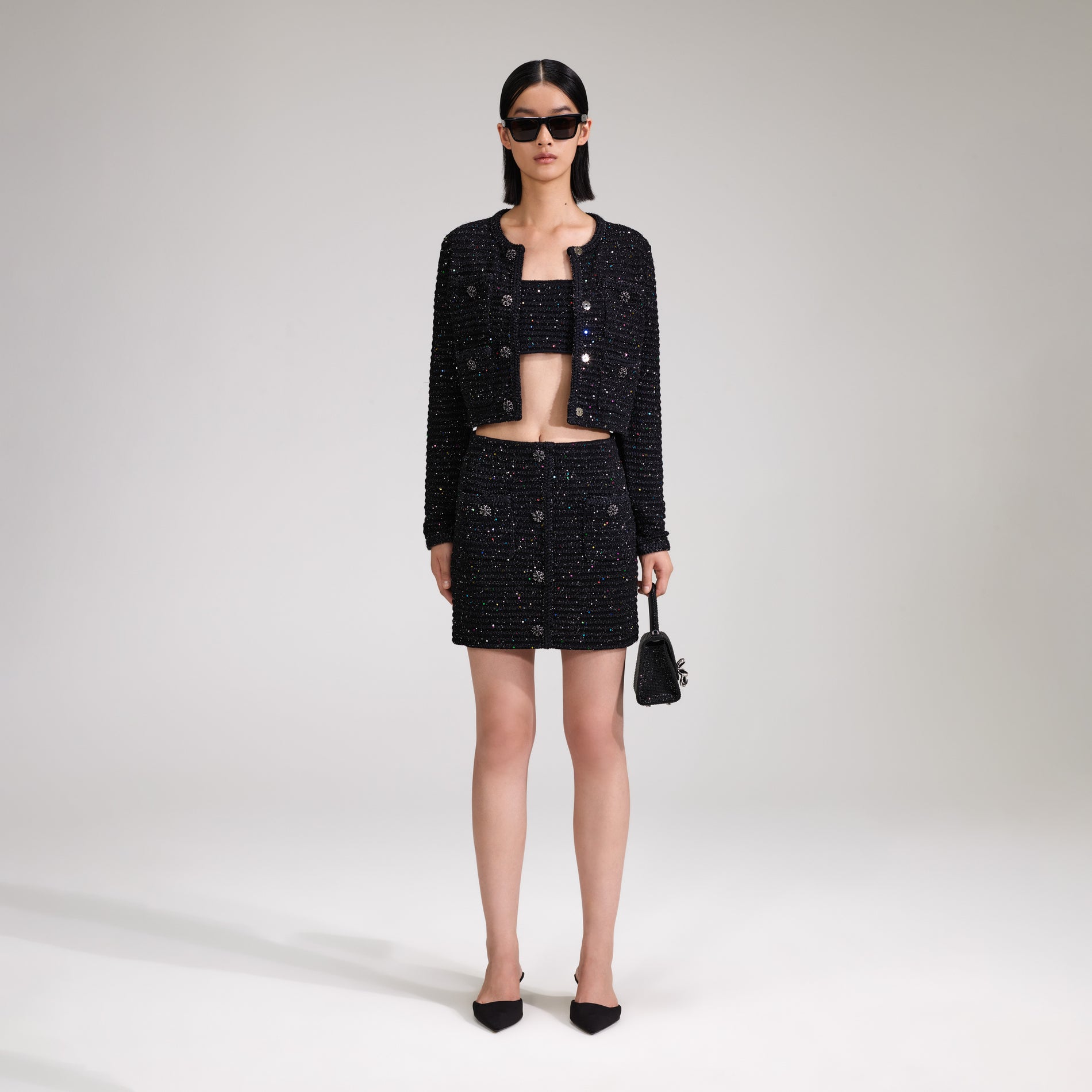 A woman wearing the Black Sequin Knit Skirt